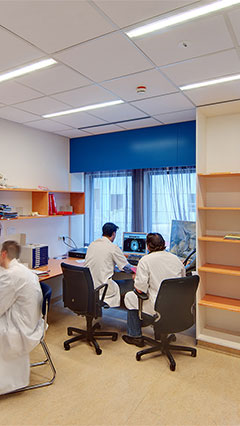 People work by the light of Philips' hospital energy saving lighting in this UMCG office