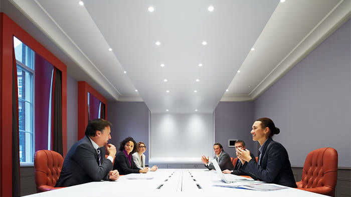 People attending a meeting under Philips meeting room lighting