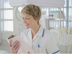 Nurse holding a baby in a hospital 