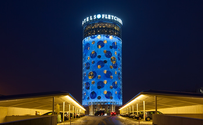 The front side of the Fletcher hotel impressively illuminated by Philips and Livingprojects